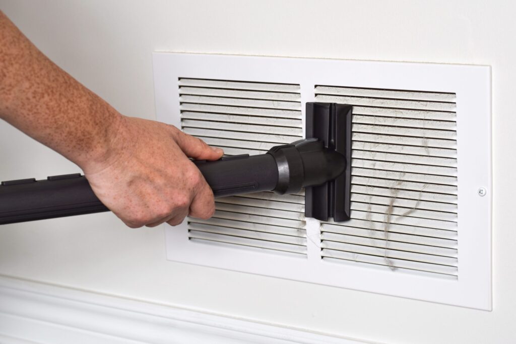 Beyond the AC: Spring Cleaning Tips for Optimal Home Comfort 2 vacuuming dirty return air vents